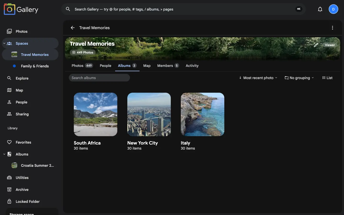 A Shared Space called Travel Memories with its Albums tab selected, showing three albums — South Africa, New York City, and Italy — each as a cover card with an item count, alongside the space navigation for Photos, People, Albums, Map, Members, and Activity